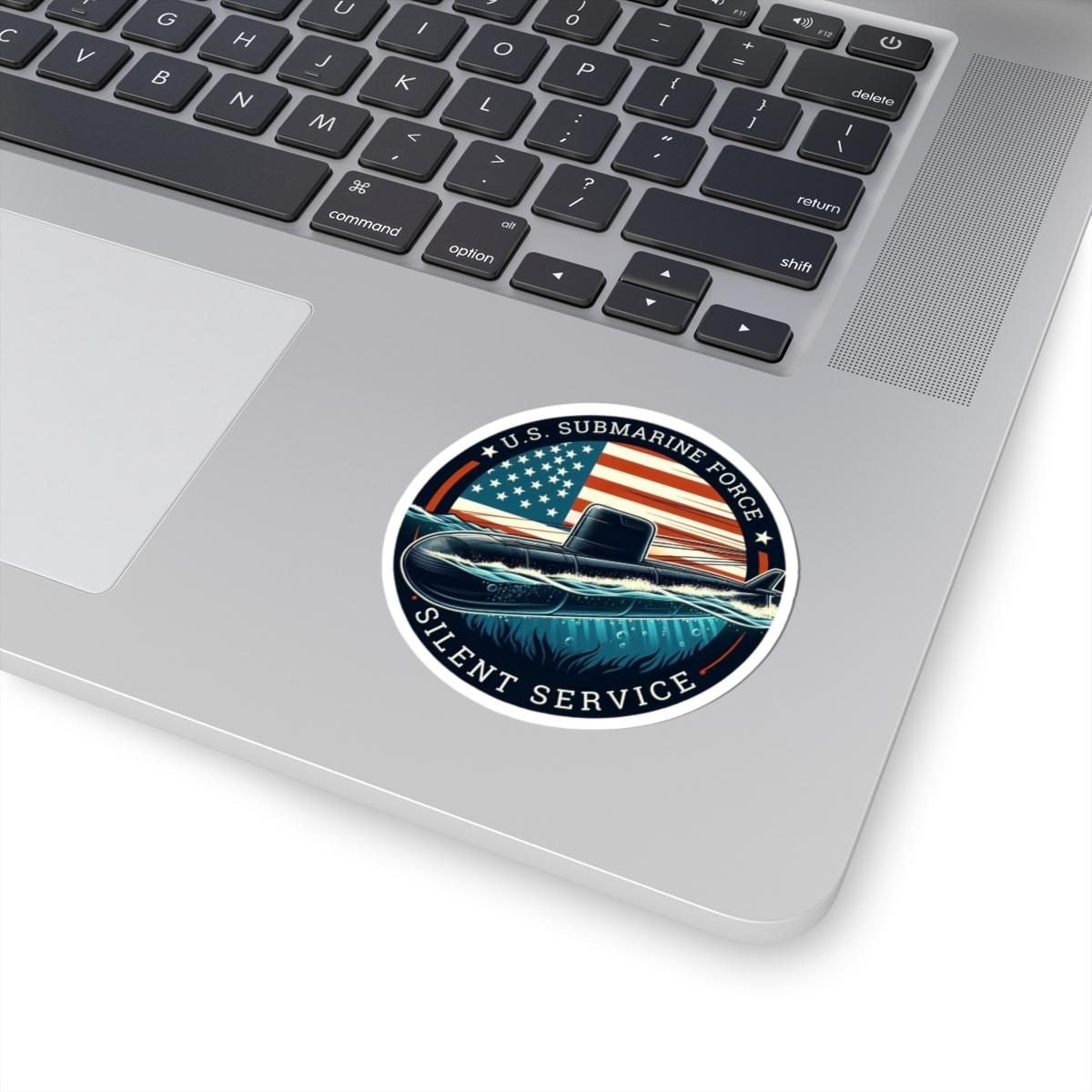 Silent Service submarine sticker on a silver laptop below the keyboard
