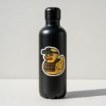 Tactical rubber duck sticker on a black water bottle against a plain wall