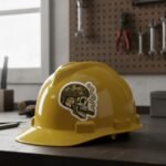 Tactical skull sticker on a yellow hard hat on a workshop bench