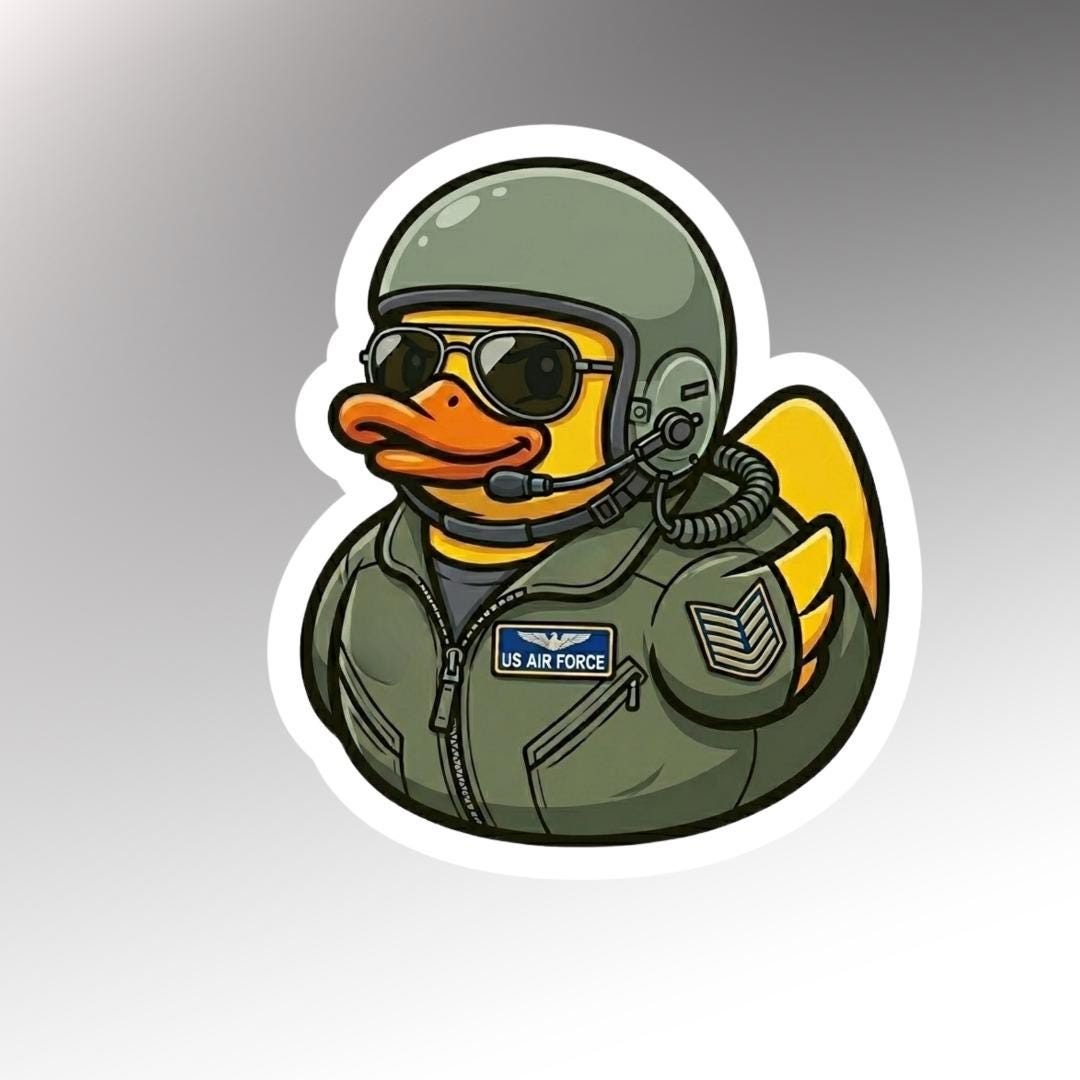 Die-cut sticker of a rubber duck in an olive flight suit, helmet, headset and sunglasses with a U.S. Air Force name tape