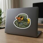 Air Force duck sticker on the back of a gray laptop on a desk