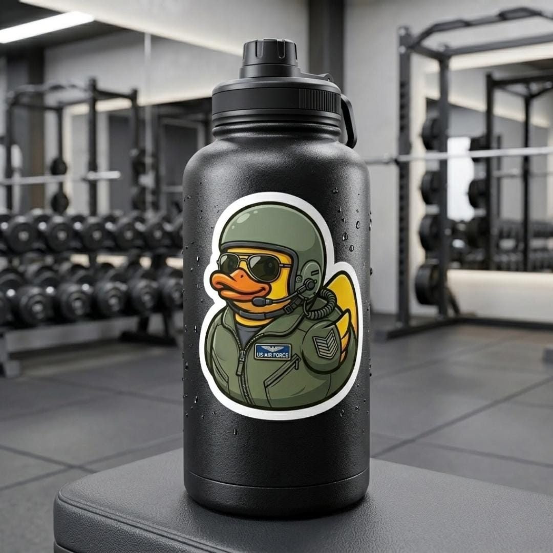 Air Force duck sticker on a black water bottle in a gym with weights behind it